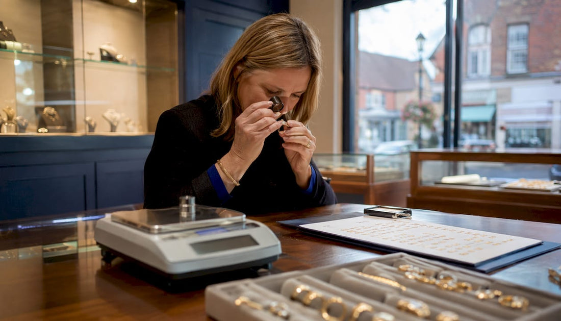 Jeweller inspecting gold ring in Kent shop