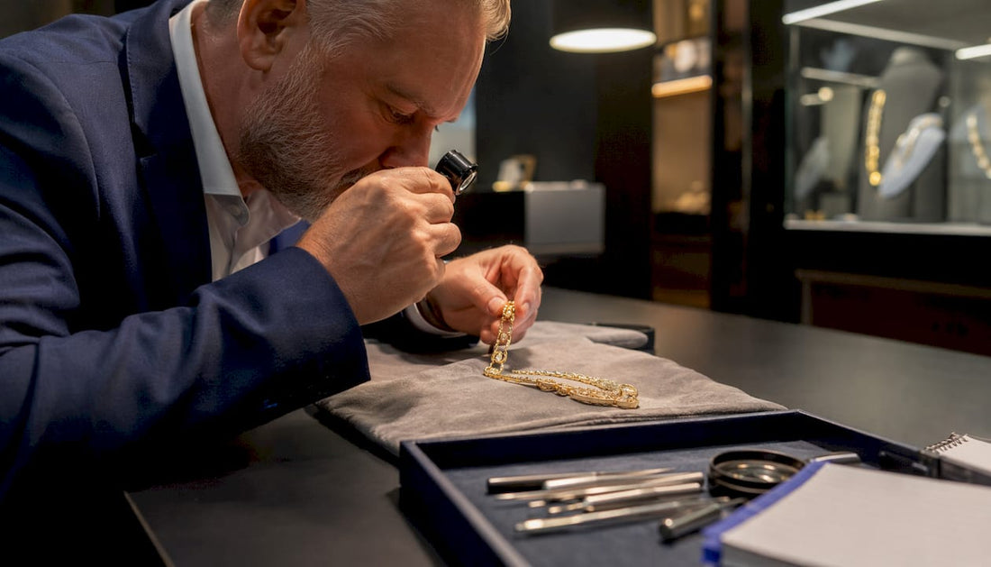 Appraiser examining gold jewellery in appraisal room