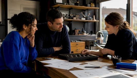 Couple consulting jeweller on handmade rings