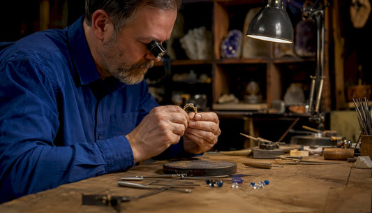 Jeweller inspecting ring at high street shop