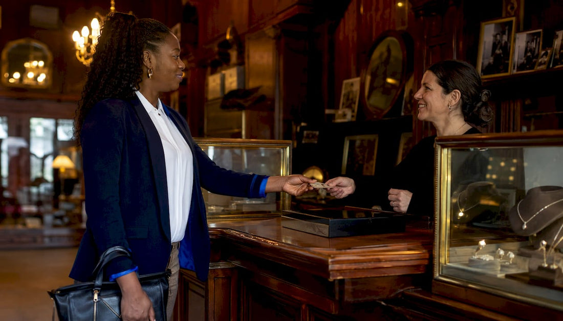 Woman handing photo ID at pawnbroker counter