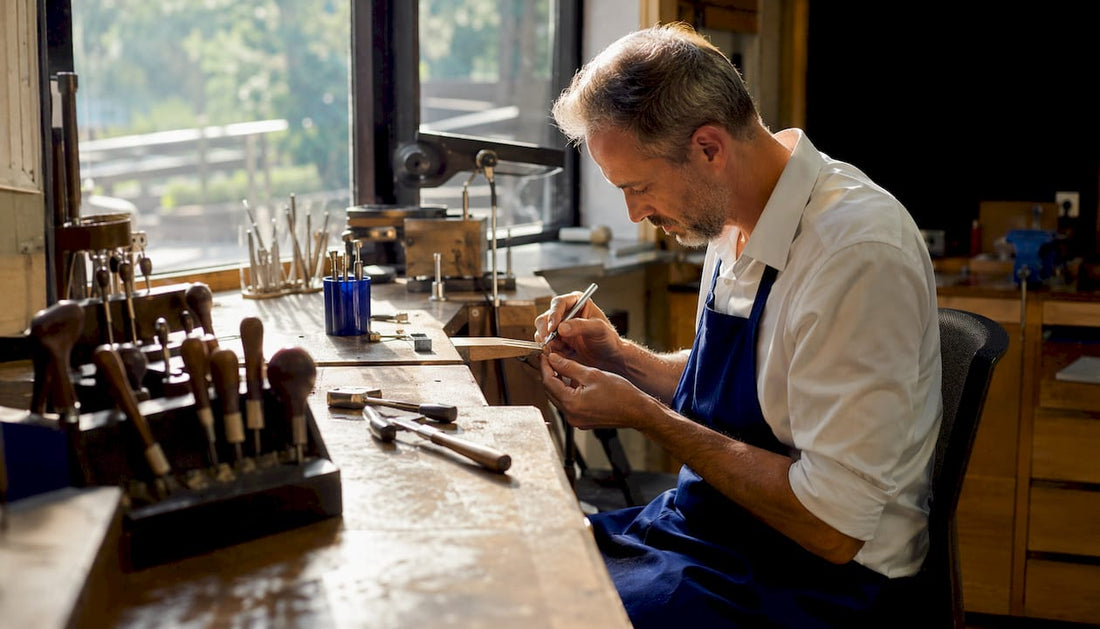 Jeweller crafting custom gold ring at bench