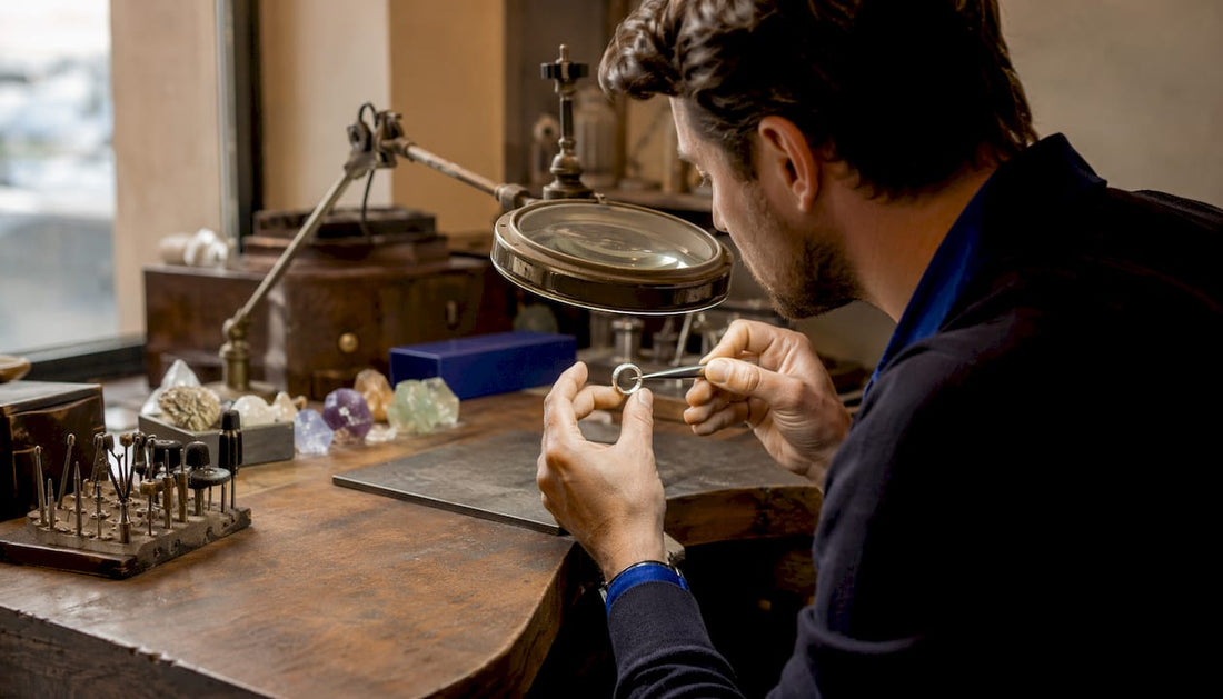 Jeweller inspecting white gold ring for plating