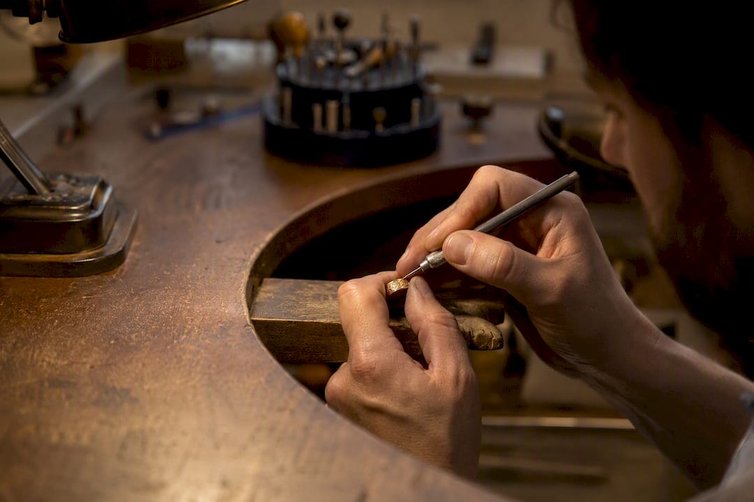Jeweller engraving gold wedding ring