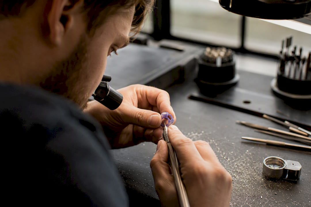 Jeweller adjusting wax ring model