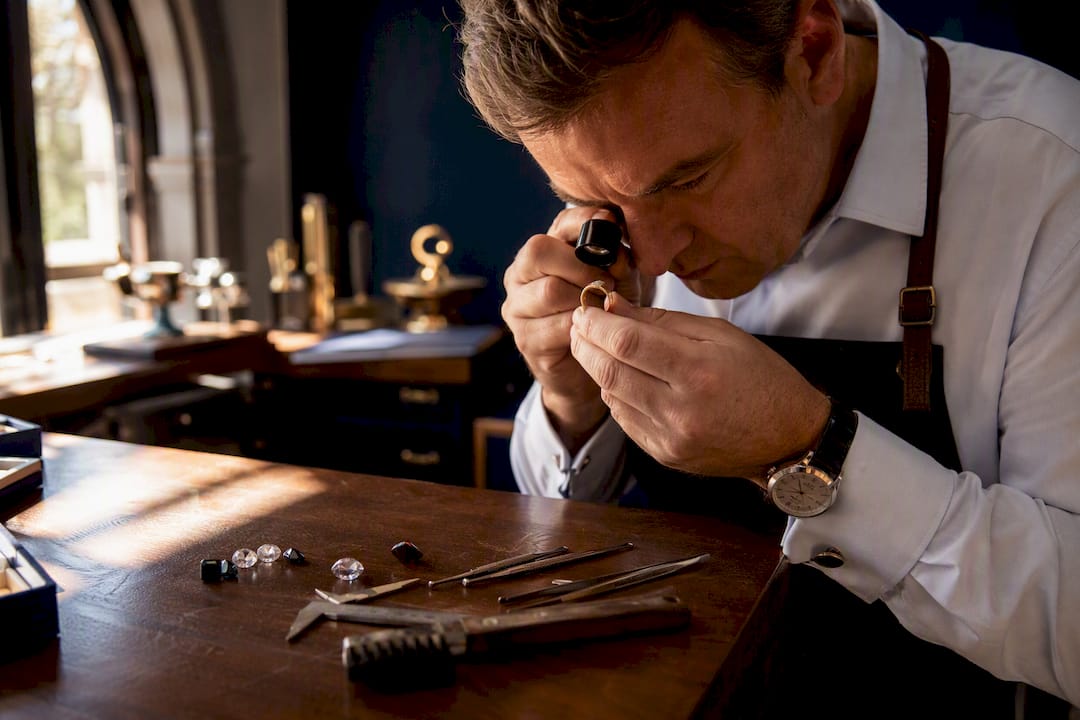 Jeweller inspecting gold ring hallmark