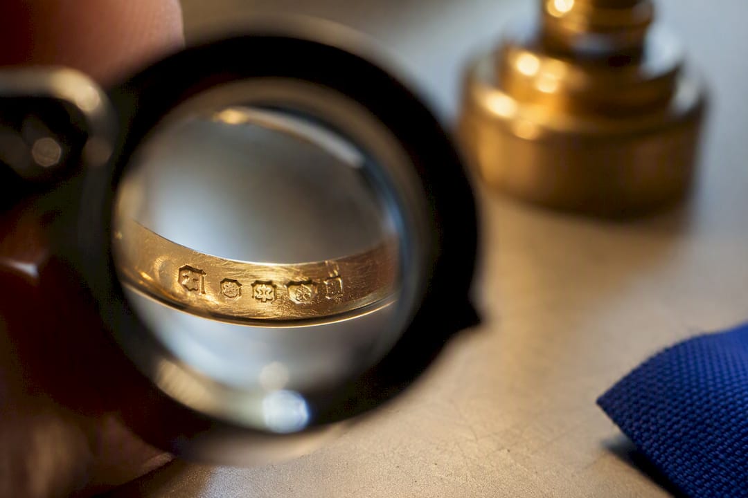 Jeweller examining a gold hallmark