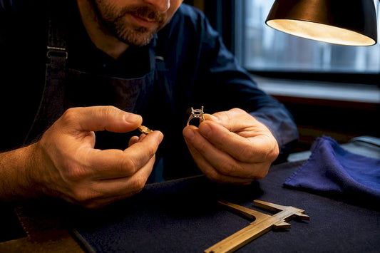 Jeweller comparing gold and bespoke ring setting