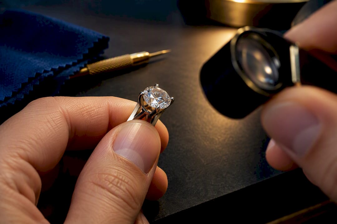 Jeweller checking cropped diamond setting