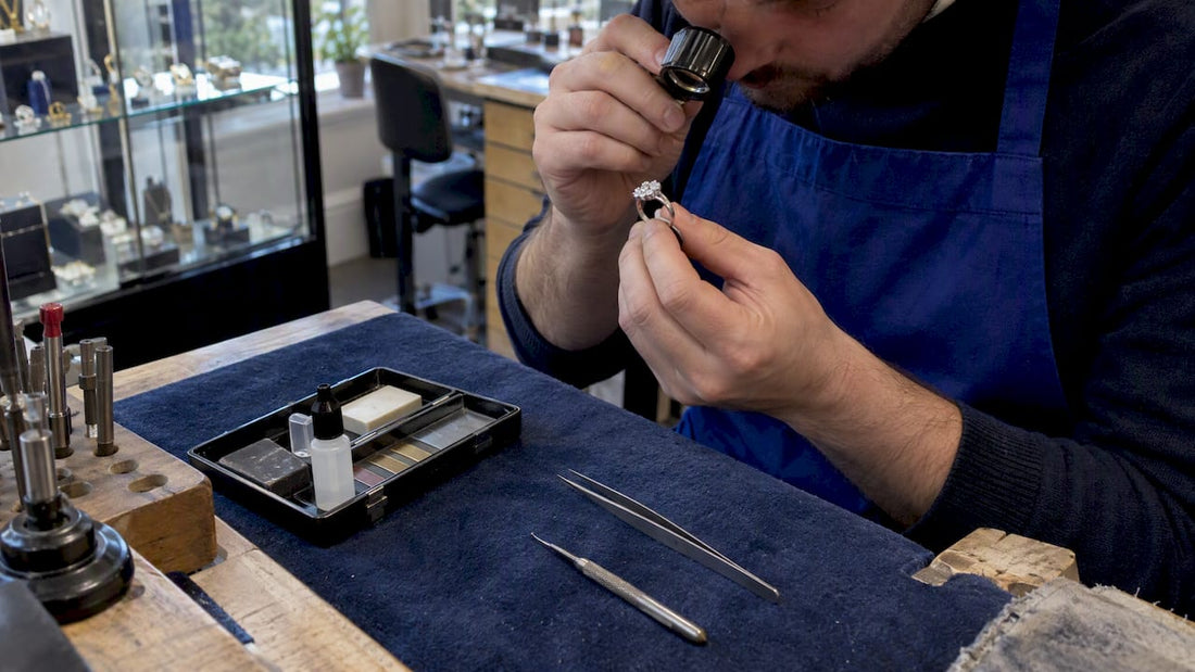 Jeweller inspecting cluster ring hallmark