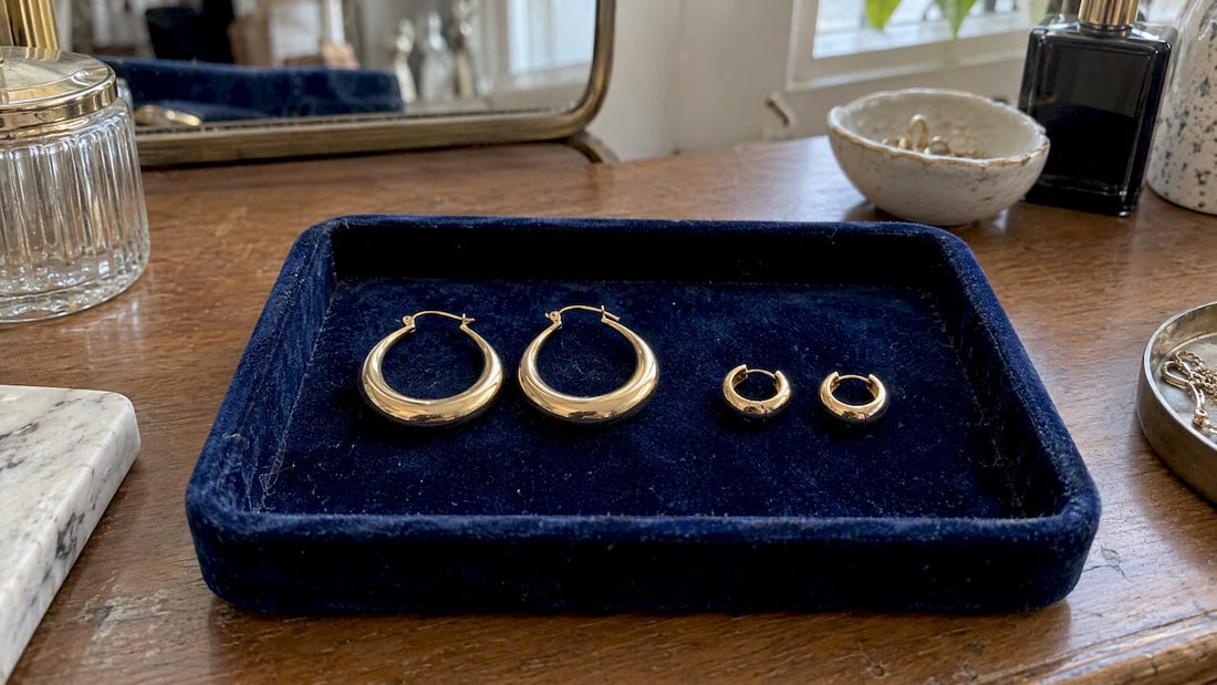 Creole earrings beside compact huggie hoops